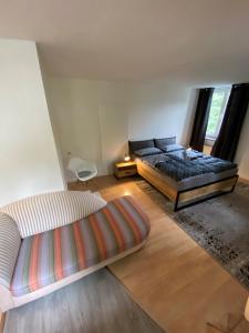 a bedroom with two beds and a large window at Altstadtwohnung - Old Town in Trostberg an der Alz