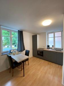 a kitchen with a table and a dining room at Altstadtwohnung - Old Town in Trostberg an der Alz