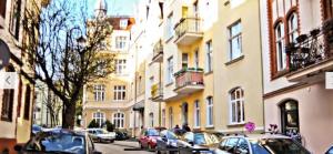 a row of cars parked on a street next to buildings at Sopot, the very heart! in Sopot