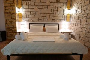 A bed or beds in a room at Oceanic Overview Suites