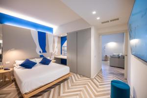 a bedroom with a bed and a blue ceiling at Amarina Hotel in Marina di Pietrasanta +62 photos