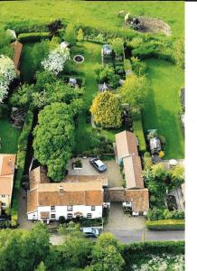 an aerial view of a house with a yard at Cobweb Cottage in Spooner Row