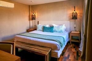 a bedroom with a large bed with blue pillows at Casa de Huéspedes Bodega Gimenez Riili in Los Sauces +29 photos