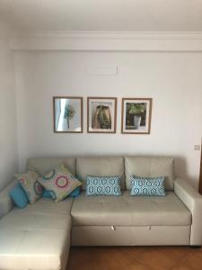a living room with a couch with pillows on it at PÉ NA AREIA by Stay in Alentejo in Vila Nova de Milfontes