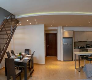 a dining room and kitchen with a table and chairs at SeastheDayApartment in Nea Peramos