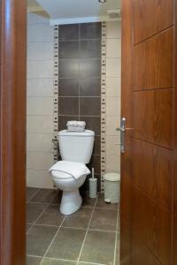 a bathroom with a toilet and a wooden door at SeastheDayApartment in Nea Peramos +28 photos