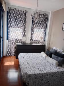 a bedroom with a bed and two large windows at Vistas del Guadiana in Ayamonte