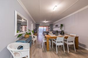 a dining room with a table and chairs at Beacon Wharf , George Hay 5 Seafront Accommodation in Mossel Bay
