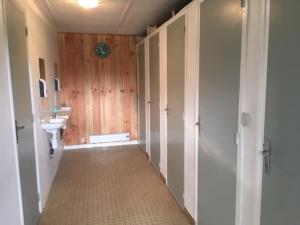 a hallway with a bathroom with a sink and a toilet at Inviting 2-Bed Cabin in DOMFRONT EN POIRAIE in Perrou
