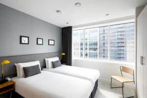 a hotel room with two beds and a window at Staycity Aparthotels Manchester Piccadilly in Manchester