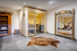 a room with a large mirror and a table with arified wood table at Chalet Ibusta - OVO Network in Le Grand-Bornand