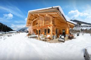 a log cabin in the snow at Chalet Ibusta - OVO Network in Le Grand-Bornand