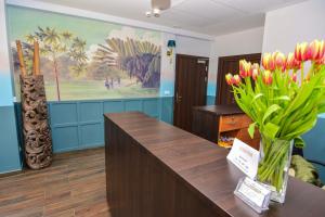 a lobby with a vase of flowers on a desk at Willa Kashmir in Mielno