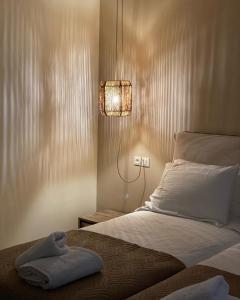 a bedroom with a bed with a light on the wall at Athena Luxury Apartments in Mesongi