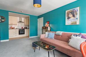 a living room with a couch and a table at Blackhorse Loft - spacious apartment by the sea in Deal