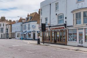 an empty city street with shops and buildings at Blackhorse Loft - spacious apartment by the sea in Deal