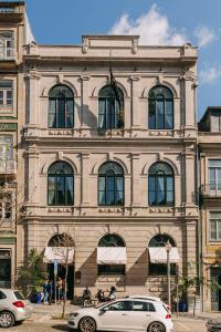 a building with cars parked in front of it at Torel 1884 Suites & Apartments in Porto
