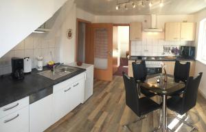 a kitchen with a table and a dining room at Ferienwohnung Lilienstein in Bad Schandau