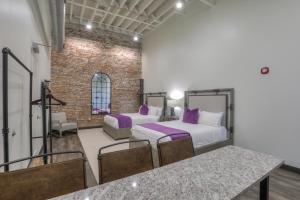 a room with two beds and a table and chairs at Studio 154 Luxury Hotel in Nashville