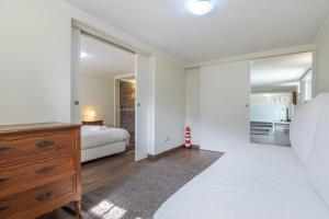 a bedroom with a bed and a dresser and a mirror at Kochab Sintra by LovelyStay in Sintra