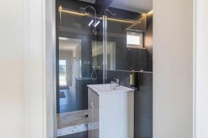 a bathroom with a sink and a mirror at Kochab Sintra by LovelyStay in Sintra