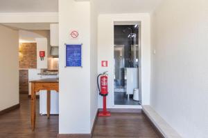 a hallway with a red fire hydrant in a house at Kochab Sintra by LovelyStay in Sintra