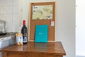a bottle of wine sitting on top of a table at Kochab Sintra by LovelyStay in Sintra