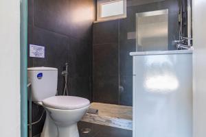 a bathroom with a toilet and a glass shower at Kochab Sintra by LovelyStay in Sintra