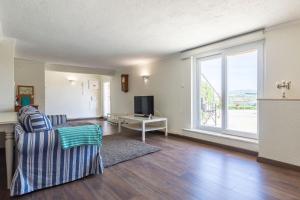 a living room with a couch and a tv at Kochab Sintra by LovelyStay in Sintra