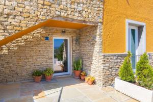 a stone building with a door and potted plants at Kochab Sintra by LovelyStay in Sintra