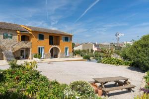 a house with a picnic table in front of it at Kochab Sintra by LovelyStay in Sintra