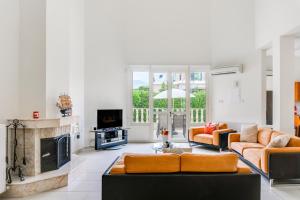 ein Wohnzimmer mit 2 Sofas und einem Kamin in der Unterkunft Villa Deja Blue by Ezoria Villas in Coral Bay