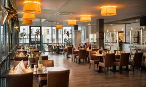 un restaurante con mesas, sillas y luces en Food Hotel en Neuwied