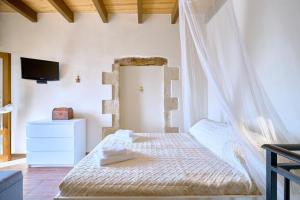 een slaapkamer met een bed met een klamboe bij Vaggelis Little Stone House in Maredhianá