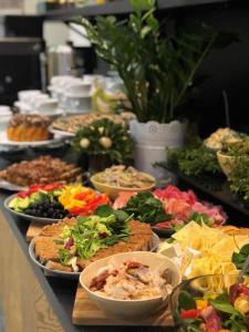 a buffet with many plates of food on a table at Villa Ozone in Sopot