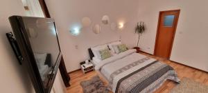 a bedroom with a bed and a tv in it at CITADEL ROOMS in Cluj-Napoca