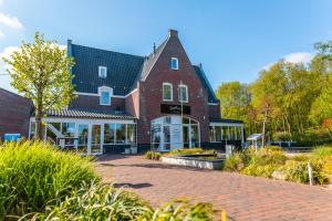 a large brick building with a brick driveway at EuroParcs Spaarnwoude in Halfweg