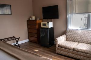 a living room with a couch and a microwave at Inn on the Hudson in Peekskill