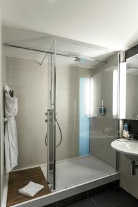 a shower with a glass door in a bathroom at Royal Antibes - Luxury Hotel, Résidence, Beach & Spa in Antibes