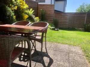 a wooden table and chairs in a yard at Big Apartment with garden Rapperswil-Jona in Jona