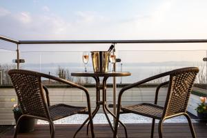 two chairs and a table on a balcony with a view at The Inn At Charlestown in Dunfermline