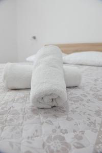 - un animal de serviettes assis au-dessus d'un lit dans l'établissement Sandy beach apartments, à Ljubač