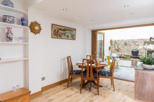 a dining room with a table and chairs at 17 Rodney Road - Luxury Apartments in Cheltenham