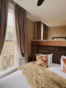 a bedroom with a bed and a window at Lace Market Hotel in Nottingham