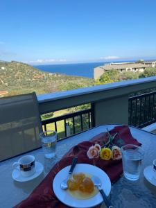 a table with two plates of food on a balcony at Giola aparments and studios 2 in Astris