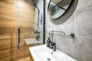 a bathroom with a sink and a mirror at Tamara Suites & Apartments in Jūrmala +41 photos