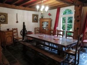 a dining room with a wooden table and chairs at GITE DU MOULIN in Renty