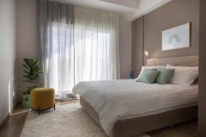 a bedroom with a large bed and a large window at Thisean Modern Suites By Athens Stay in Athens