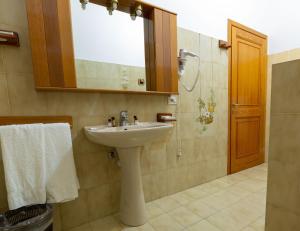 a bathroom with a sink and a mirror at Turismo Rurale CUDACCIOLU in Arzachena