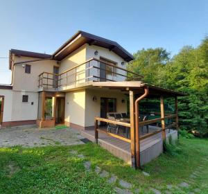 een huis met een terras en een balkon bij C House in Buşteni